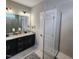 Stylish bathroom with double vanity, granite countertop, and a tiled walk-in shower at 1643 Wimberly Rd, Apex, NC 27523