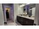 Elegant bathroom with double vanities, granite countertops, and a walk-in closet for ample storage at 1643 Wimberly Rd, Apex, NC 27523