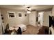 Bedroom with windows, carpet flooring, ceiling fan and access to bathroom at 1643 Wimberly Rd, Apex, NC 27523