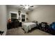 Neutral bedroom with carpet, desk and an entertainment center with storage and a blue striped bedspread at 1643 Wimberly Rd, Apex, NC 27523