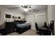 Comfortable bedroom with carpet, neutral walls, ceiling fan, desk and a wall-mounted bookcase at 1643 Wimberly Rd, Apex, NC 27523
