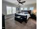 Cozy bedroom with a comfortable bed, dark furniture, and ample natural light from multiple windows at 1643 Wimberly Rd, Apex, NC 27523