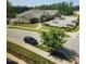 Community clubhouse featuring ample parking, manicured lawns, mature trees, and a neighborhood pool at 1643 Wimberly Rd, Apex, NC 27523