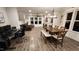 Open-concept dining area with wood table, bench and chairs, with views into the Gathering room at 1643 Wimberly Rd, Apex, NC 27523