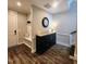 Inviting entryway featuring hardwood floors, a bench with storage, and stylish decor at 1643 Wimberly Rd, Apex, NC 27523