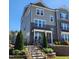 Charming townhome with brick accents, landscaping, and inviting front steps at 1643 Wimberly Rd, Apex, NC 27523