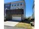 View of a two-car garage with an upper deck, offering convenient parking and outdoor space at 1643 Wimberly Rd, Apex, NC 27523