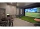 Golf simulator room featuring sports equipment, chairs, and a table at 1643 Wimberly Rd, Apex, NC 27523