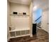 Hallway with coat rack, bench, and hardwood floors; offers functionality and style at 1643 Wimberly Rd, Apex, NC 27523