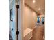 Bright hallway featuring neutral walls, carpet flooring, and a white storage bench at 1643 Wimberly Rd, Apex, NC 27523