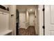 Hallway with coat rack and dark wood floors leading to multiple rooms at 1643 Wimberly Rd, Apex, NC 27523
