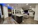 Well-appointed kitchen featuring stainless steel appliances, granite island and seamless flow into living room at 1643 Wimberly Rd, Apex, NC 27523