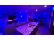 Modern kitchen with granite countertops overlooking an open-concept living area with fireplace and TV at 1643 Wimberly Rd, Apex, NC 27523