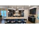 Stylish kitchen with an island, stainless steel appliances, modern lighting, and elegant cabinetry at 1643 Wimberly Rd, Apex, NC 27523