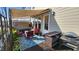 Charming patio with retractable awning, outdoor seating, and a grill, perfect for entertaining at 1643 Wimberly Rd, Apex, NC 27523