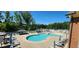 Community pool and lounge area with ample seating and umbrellas for relaxation and enjoyment at 1643 Wimberly Rd, Apex, NC 27523