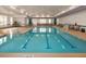 Indoor swimming pool featuring ample lounge seating and large windows at 1643 Wimberly Rd, Apex, NC 27523