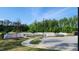 Exterior shot of the community pool area, featuring a surrounding fence and green trees on a sunny day at 1643 Wimberly Rd, Apex, NC 27523