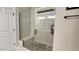 Beautifully tiled shower with a glass enclosure and pebble floor, offering a spa-like experience at 1643 Wimberly Rd, Apex, NC 27523