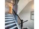 Staircase with dark wood steps and white risers, complemented by gray walls and stylish accents at 1643 Wimberly Rd, Apex, NC 27523