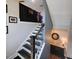 Staircase with wooden steps and black railings, leading to an upper level with views of decor at 1643 Wimberly Rd, Apex, NC 27523