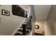 Elegant staircase featuring dark wood steps and a black iron railing, complemented by neutral-toned walls at 1643 Wimberly Rd, Apex, NC 27523