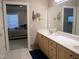Bathroom with double sink vanity, gold fixtures, and a view into the main bedroom at 2002 Clyde Bank Ct, Cary, NC 27511