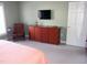 Bedroom with large TV, chair and neutral carpet at 2002 Clyde Bank Ct, Cary, NC 27511
