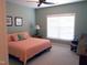 Bright bedroom with large window, ceiling fan, and neutral carpet at 2002 Clyde Bank Ct, Cary, NC 27511