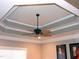 Detailed tray ceiling design with crown molding and a ceiling fan, adding architectural interest to the room at 2002 Clyde Bank Ct, Cary, NC 27511