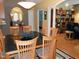 Dining room with a dark wood table, seating for six, overhead lighting, and wood floors at 2002 Clyde Bank Ct, Cary, NC 27511