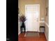 Inviting entryway with hardwood floors, neutral paint, decor, and white door at 2002 Clyde Bank Ct, Cary, NC 27511