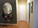 Inviting entryway with hardwood floors and an oval mirror over a modern table at 2002 Clyde Bank Ct, Cary, NC 27511