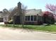 Brick home with attached garage, mature trees, manicured shrubs, and well-maintained lawn at 2002 Clyde Bank Ct, Cary, NC 27511