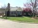 Charming brick home with manicured lawn and colorful flowering trees at 2002 Clyde Bank Ct, Cary, NC 27511
