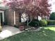 Lush green lawn, red maple tree, and manicured shrubs, complete with brick accents and clean landscaping at 2002 Clyde Bank Ct, Cary, NC 27511