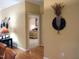Hallway with hardwood floors leads to a bedroom with a glimpse of a bed, connecting the living spaces at 2002 Clyde Bank Ct, Cary, NC 27511