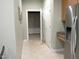 Hallway view with stainless fridge, doorway and tile flooring at 2002 Clyde Bank Ct, Cary, NC 27511