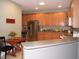 Well-lit kitchen featuring stainless steel appliances, ample cabinet space, and an adjacent dining area at 2002 Clyde Bank Ct, Cary, NC 27511