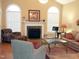 Cozy living room with fireplace, hardwood floors, and comfortable furniture at 2002 Clyde Bank Ct, Cary, NC 27511