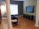 Comfortable living room featuring wood floors, a sofa, and entertainment area with large-screen television at 2002 Clyde Bank Ct, Cary, NC 27511