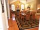 Open-concept living and dining area with hardwood floors, fireplace, dining table, and view into the living room at 2002 Clyde Bank Ct, Cary, NC 27511