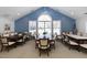 Community meeting room with tables and blue accent wall at 2002 Clyde Bank Ct, Cary, NC 27511