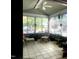 Bright sunroom featuring tile floors, ceiling fan, and many windows with views of the outdoor scenery at 2002 Clyde Bank Ct, Cary, NC 27511