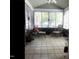 Bright sunroom featuring tile floors, ceiling fan, and many windows with views of the outdoor scenery at 2002 Clyde Bank Ct, Cary, NC 27511
