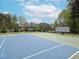A fenced in community basketball court is designed with blue and green, and has basketball net at 2067 White Pond Ct, Apex, NC 27523