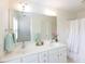 Elegant bathroom with double sinks, a large mirror, and plentiful storage at 2067 White Pond Ct, Apex, NC 27523