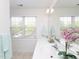 Bright bathroom with double sinks, large mirror, and a window at 2067 White Pond Ct, Apex, NC 27523