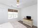 Bright bedroom featuring a ceiling fan, natural light from the window and a modern dresser at 2067 White Pond Ct, Apex, NC 27523