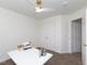 Bright bedroom featuring a ceiling fan and large windows, furnished with a work desk and closet at 2067 White Pond Ct, Apex, NC 27523